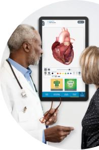 Male doctor and female patient looking at a 3D model of a heart on an exam room display.