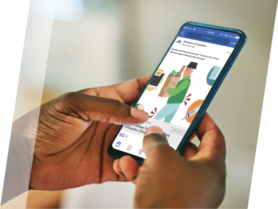 Hands holding mobile phone with Facebook display ad promoting doctor's office