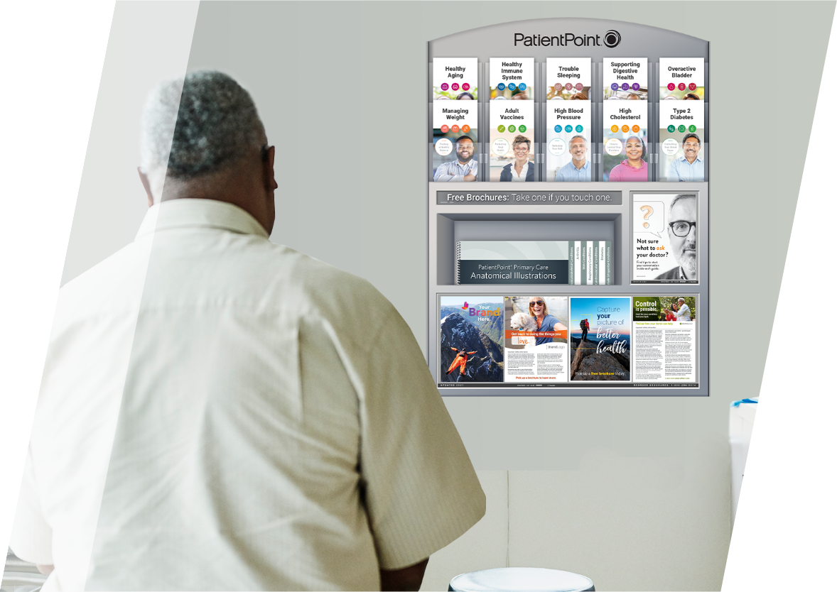 Male patient in an exam room looking at a PatientPoint brochure display with advertisements.