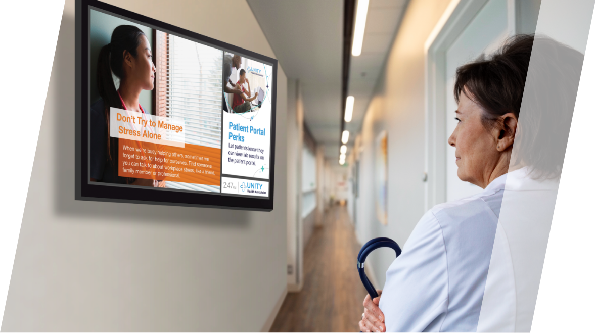 Female doctor watching PatientPoint back office digital screen.