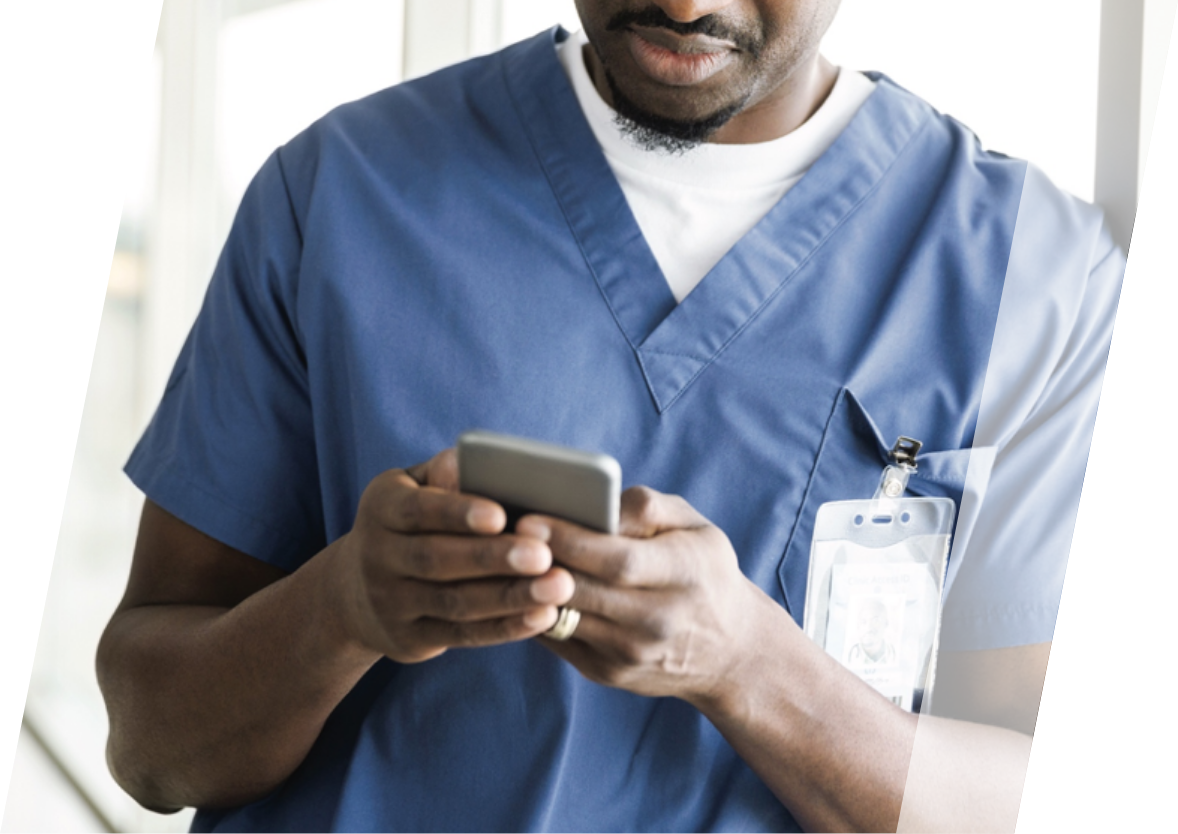 African American male doctor using a cell phone on break.